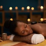 Young woman enjoying stone massage in luxury spa salon